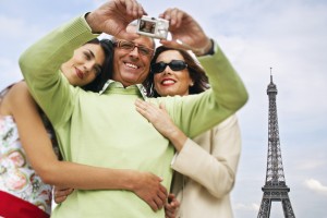 Family Using Digital Camera in Front of Eiffel Tower