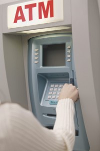 Woman Using Atm Machine --- Image by © Royalty-Free/Corbis